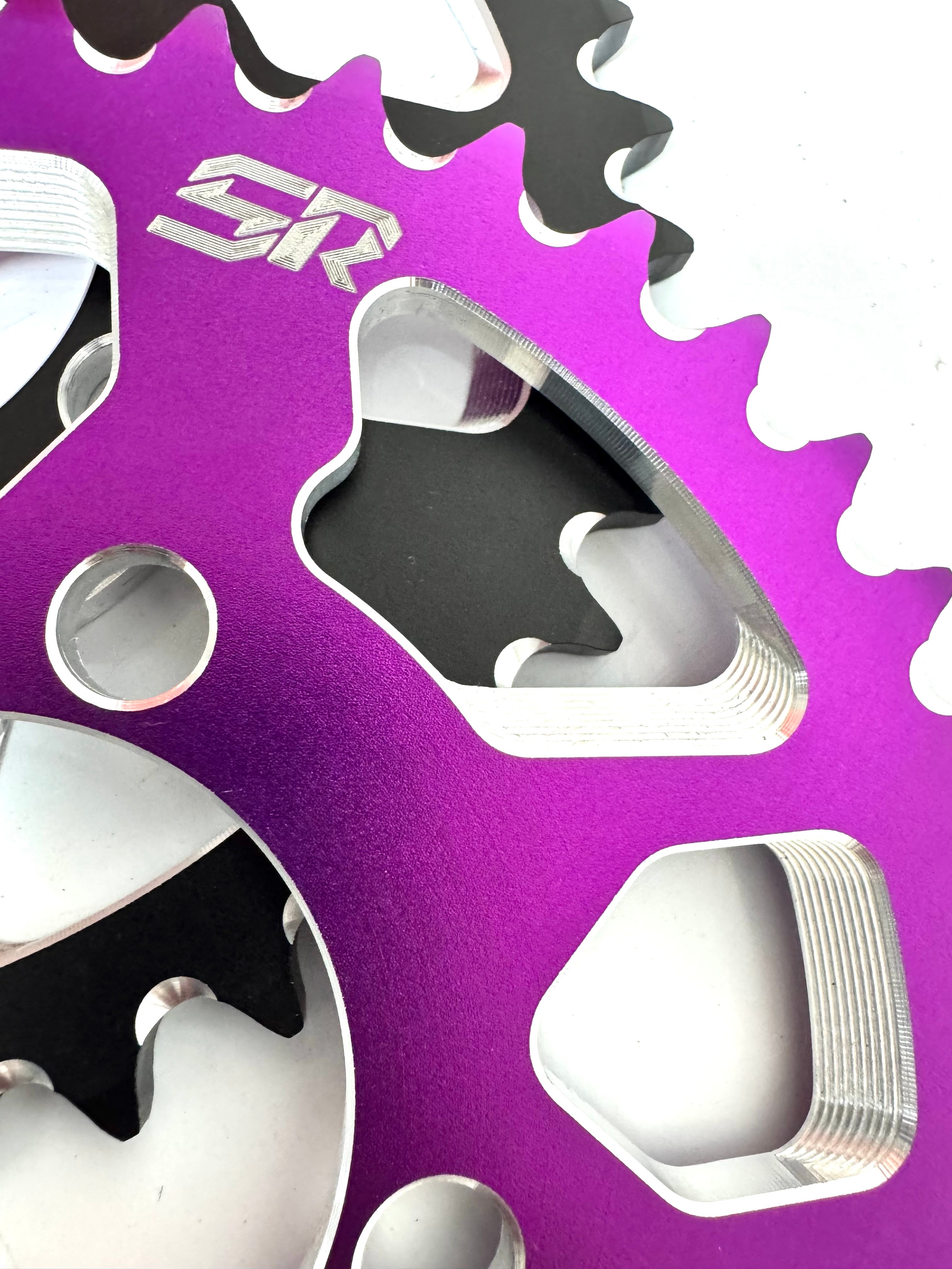 Close-up of a purple sprocket with 'SR' branding on a white background